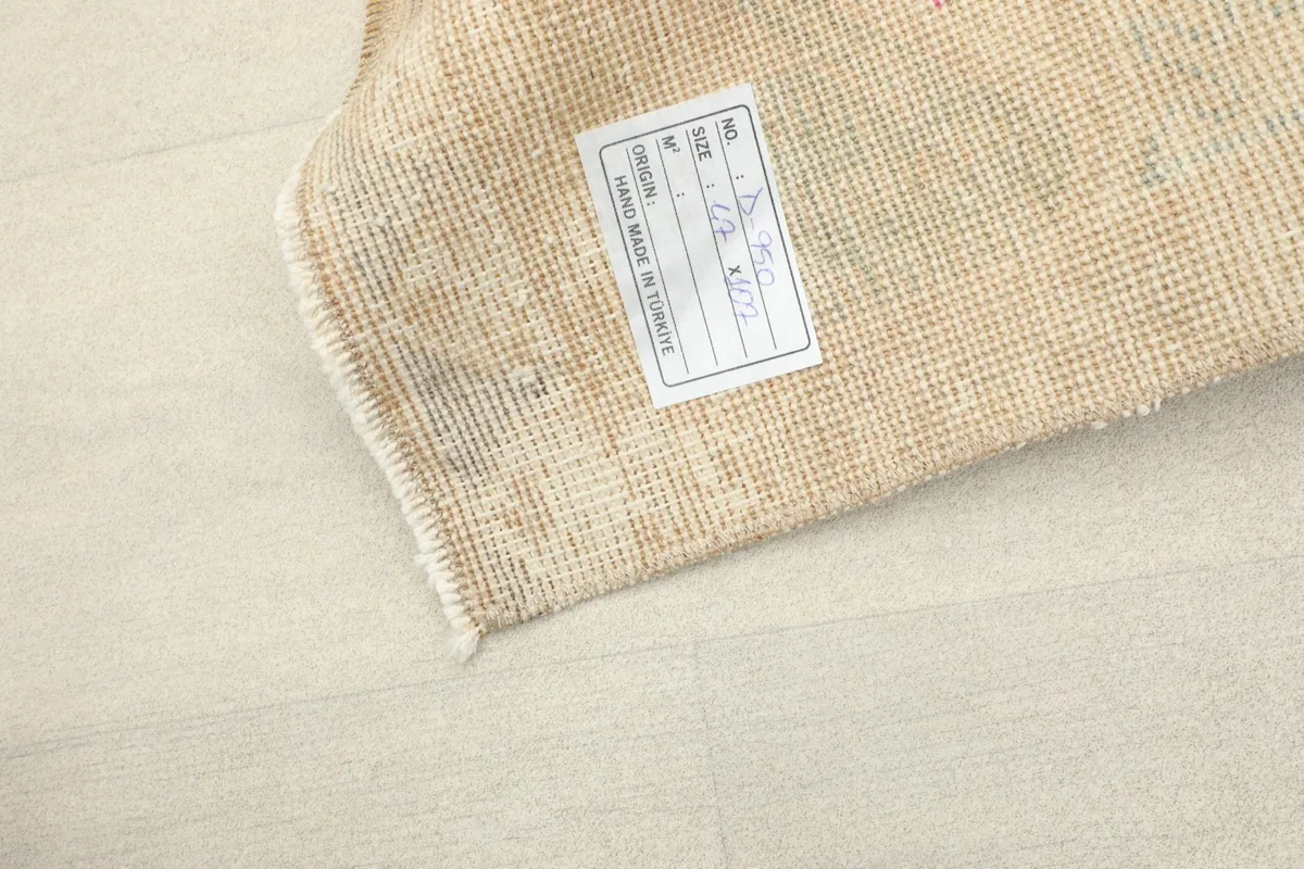 Close-up of the rug's back with a label, showcasing the professional cleaning and origin.