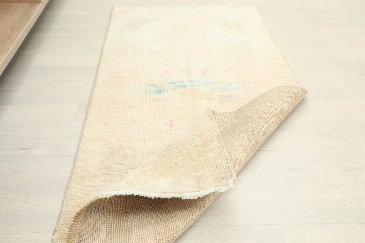 Another view of the rug partially folded, illustrating its soft drape and texture.