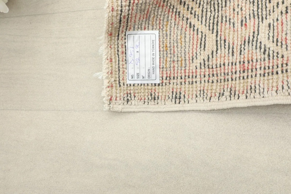 Close-up of the rug's back, displaying the tight hand-knotting and the 'Made in Turkey' label.