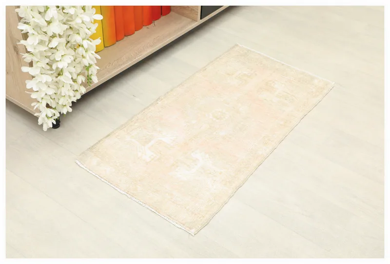 Full top view of the beige and rose vintage Anatolian rug on a white background