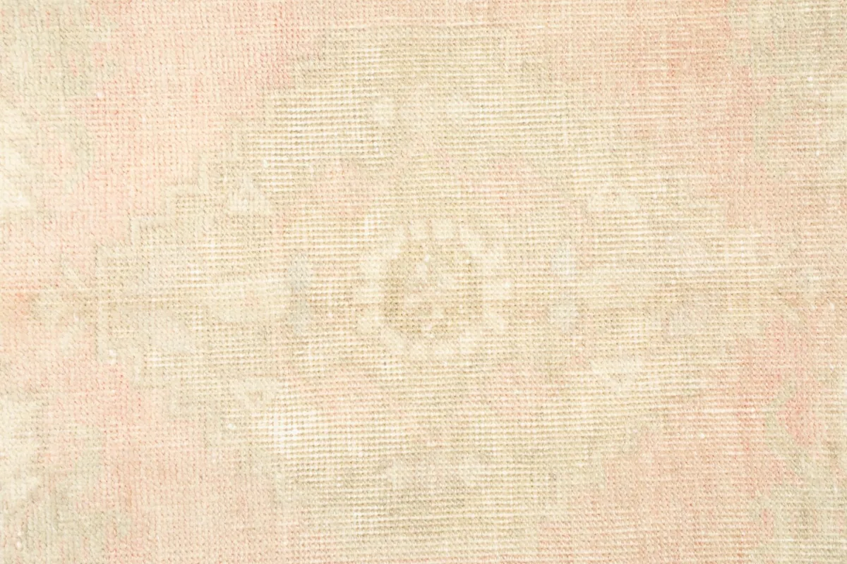 Tight shot of the rug's texture and muted geometric design, highlighting the wool pile