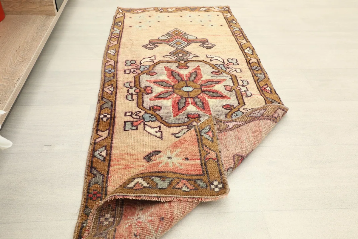Full view of the runner with one end folded back, revealing the rug's reverse side.