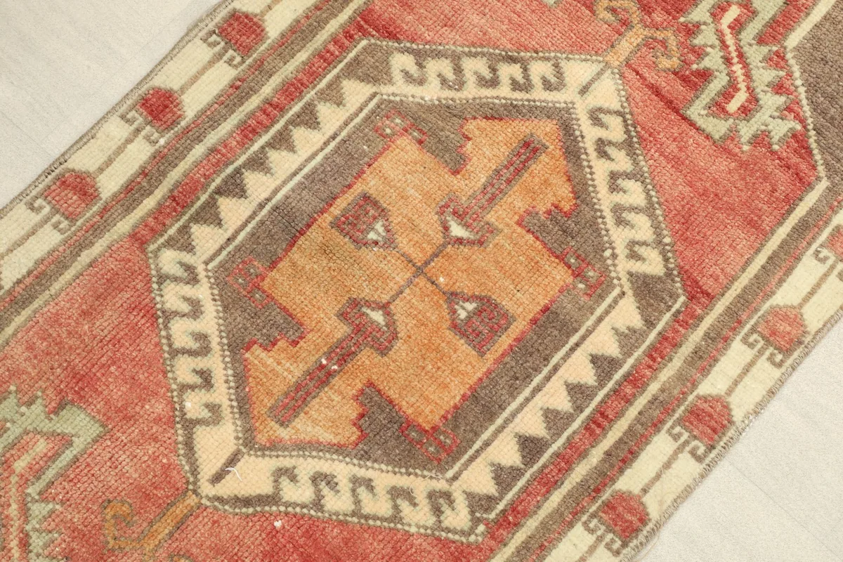 Angled view highlighting the texture and colors of the red, orange, and brown wool pile