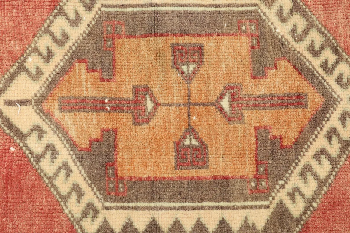 Close-up detail of the central orange and brown geometric medallion pattern