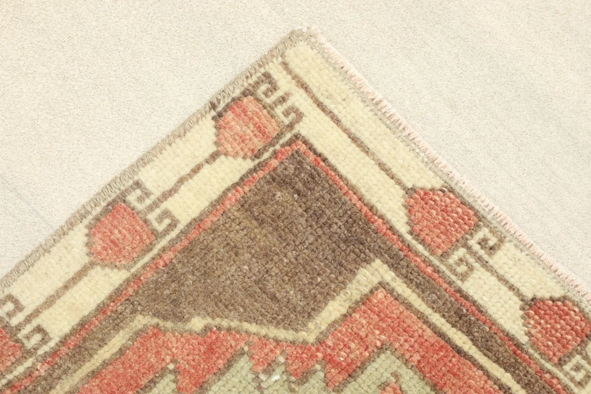 Corner detail showing the cream and brown border design with red accents