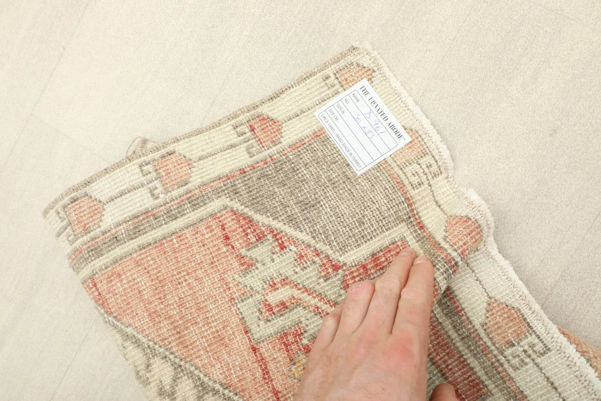 View of the rug's back, revealing the tightly hand-knotted wool on cotton construction