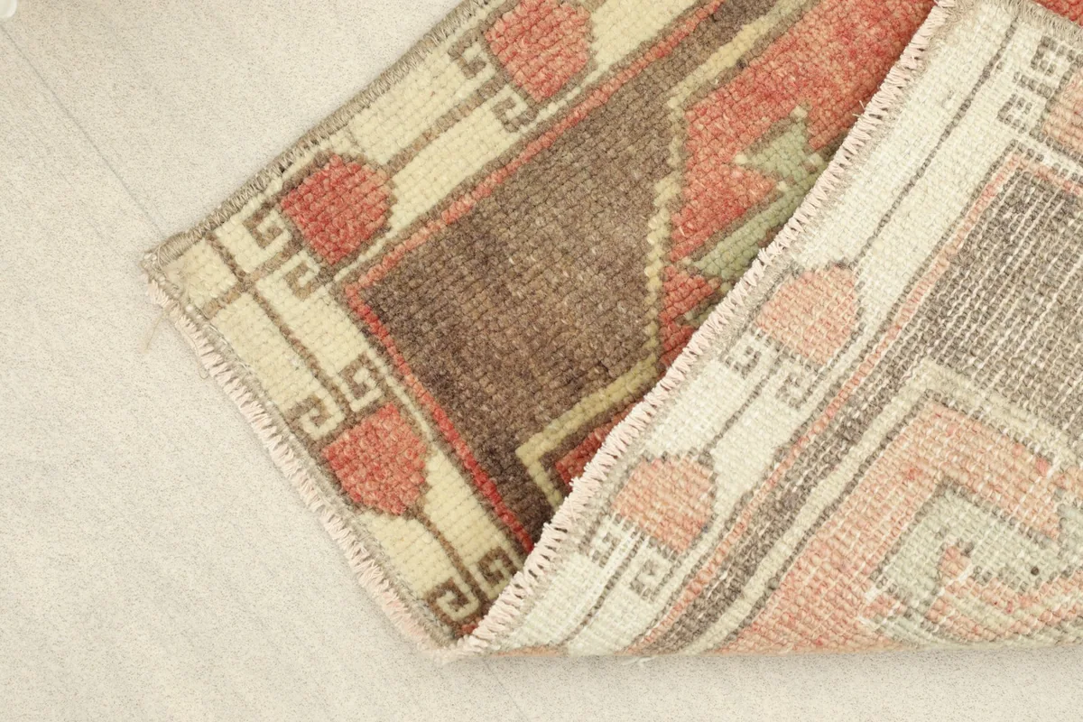 Folded view of the rug, showing the reverse side and the hand-knotted cotton foundation