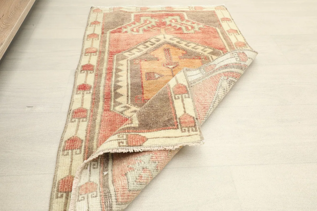 Rug partially folded, displaying both the front design and the back structure