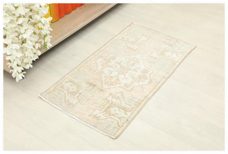 Full top view of the 1x3 beige and orange vintage Anatolian doormat on a white floor.