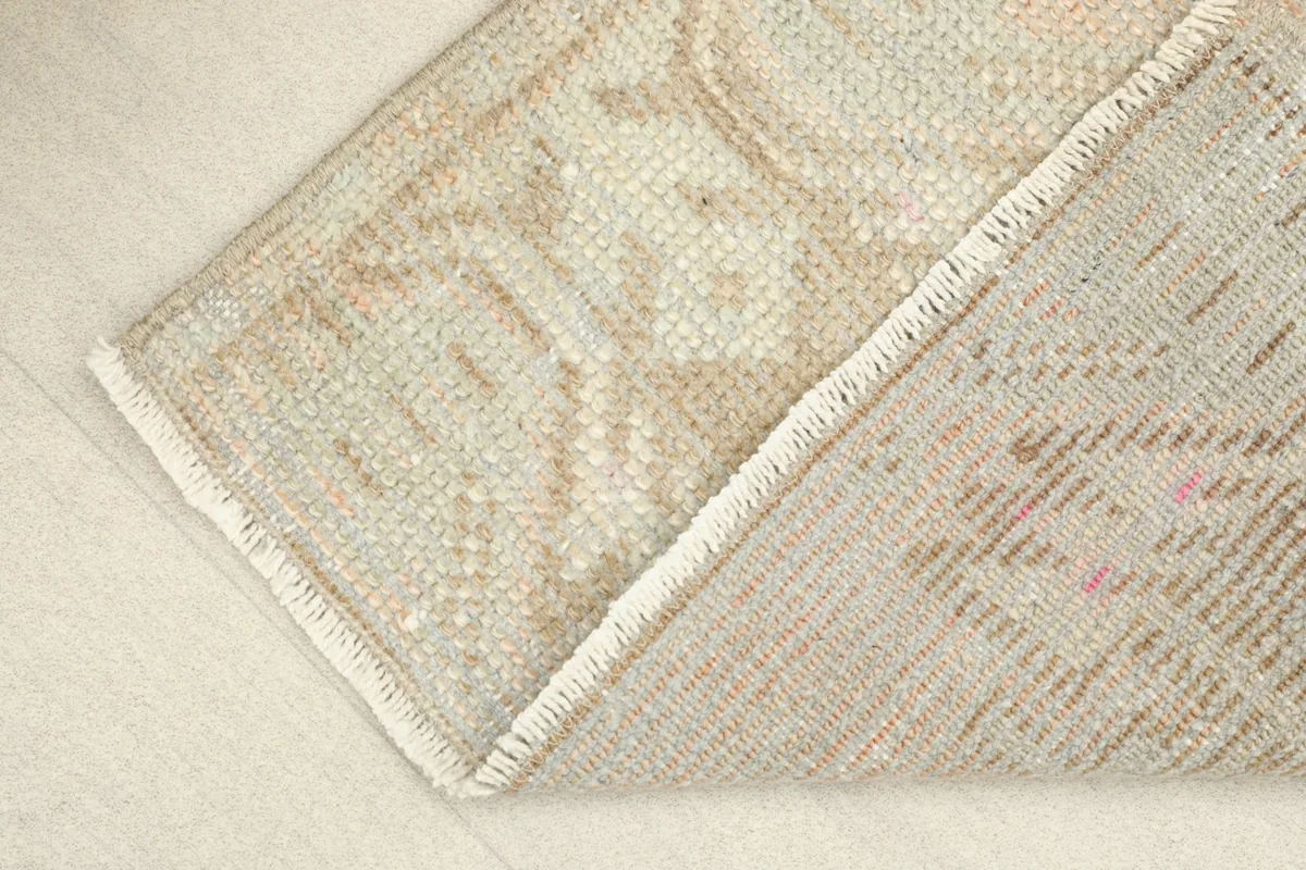 Partial view of the back of the rug, revealing the cotton foundation and tight hand-knotting.
