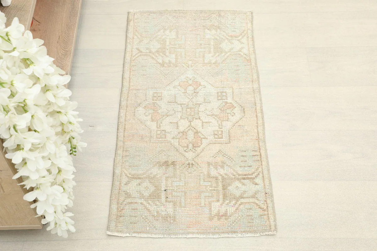Overhead view showing the full pattern of the beige geometric vintage rug.