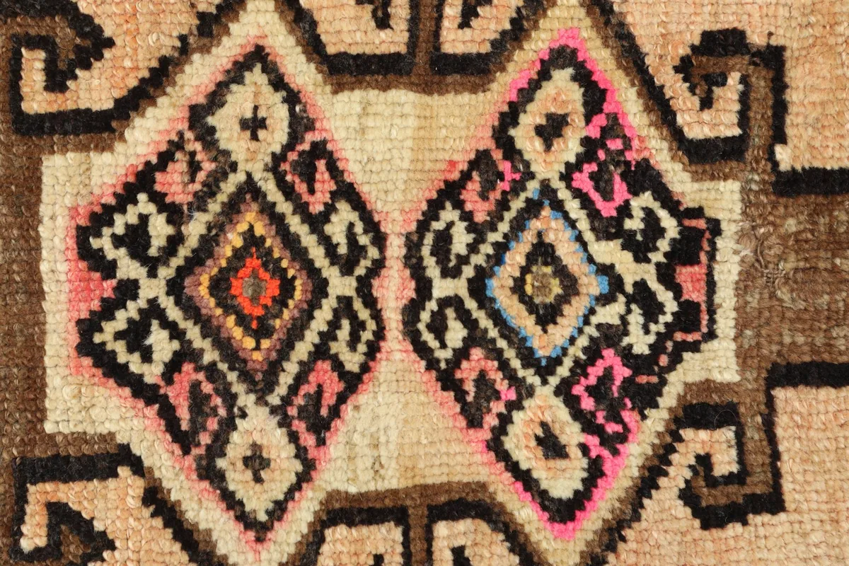 Detailed view of the hand-knotted wool pile and intricate geometric patterns.