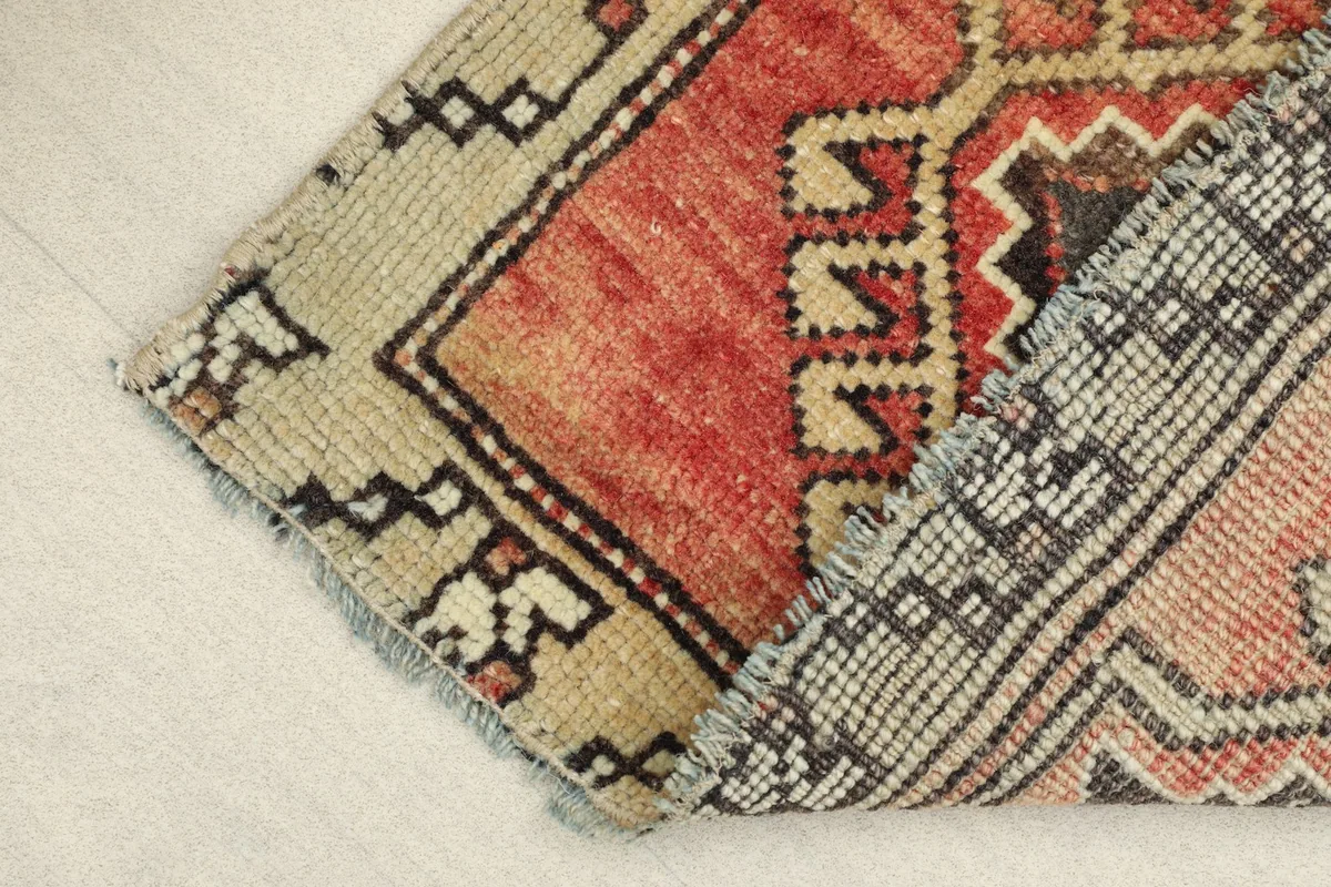 View of the rug's backside, revealing the hand-knotted construction and cotton foundation.