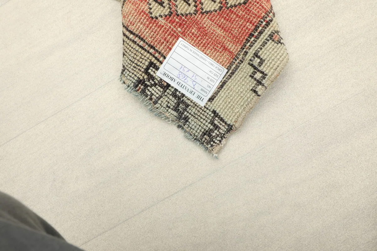 Close-up of the rug's label, confirming professional cleaning and vintage status.