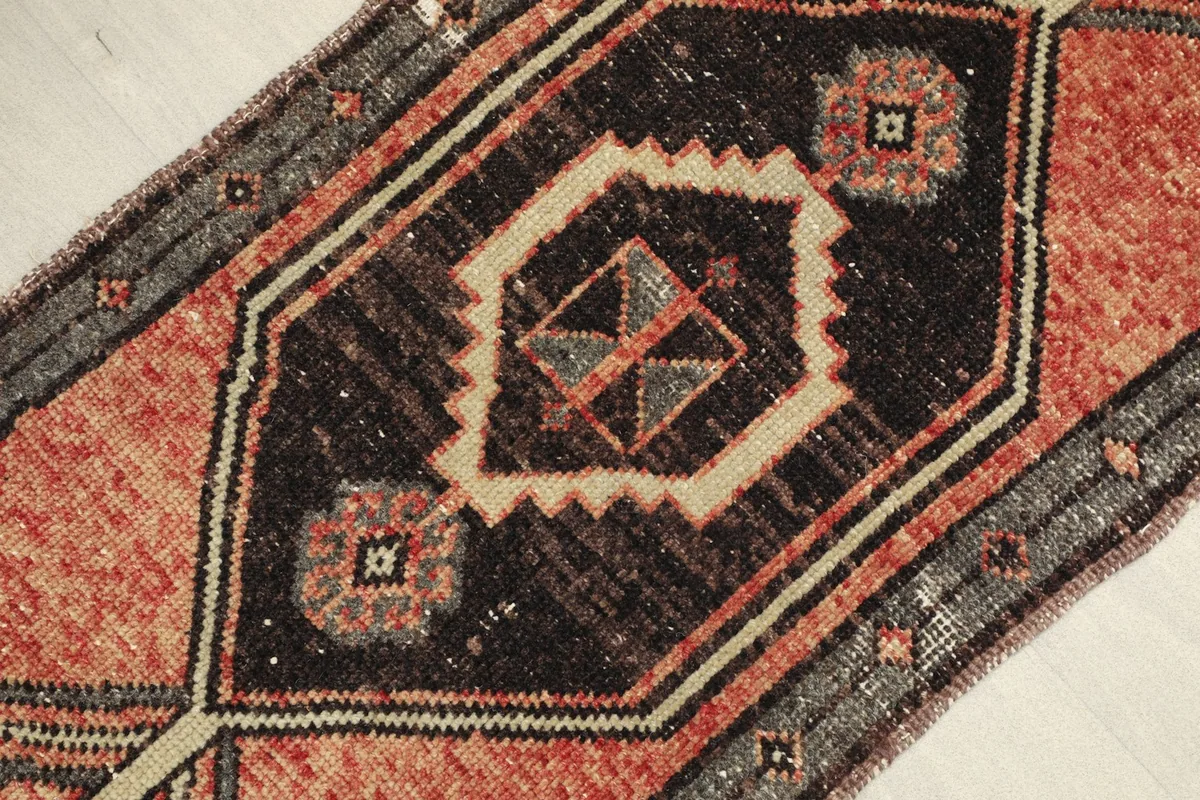 Angled view showcasing the texture and colors of the hand-knotted wool doormat.