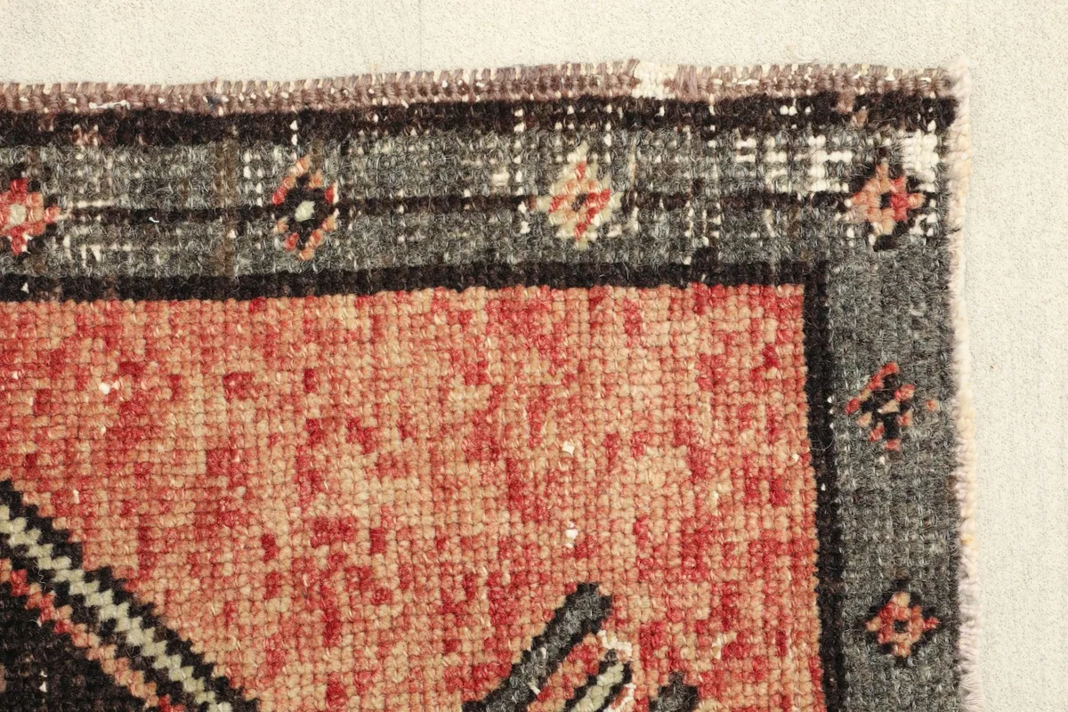 Close-up of the rust field and part of the gray border, highlighting the vintage patina.