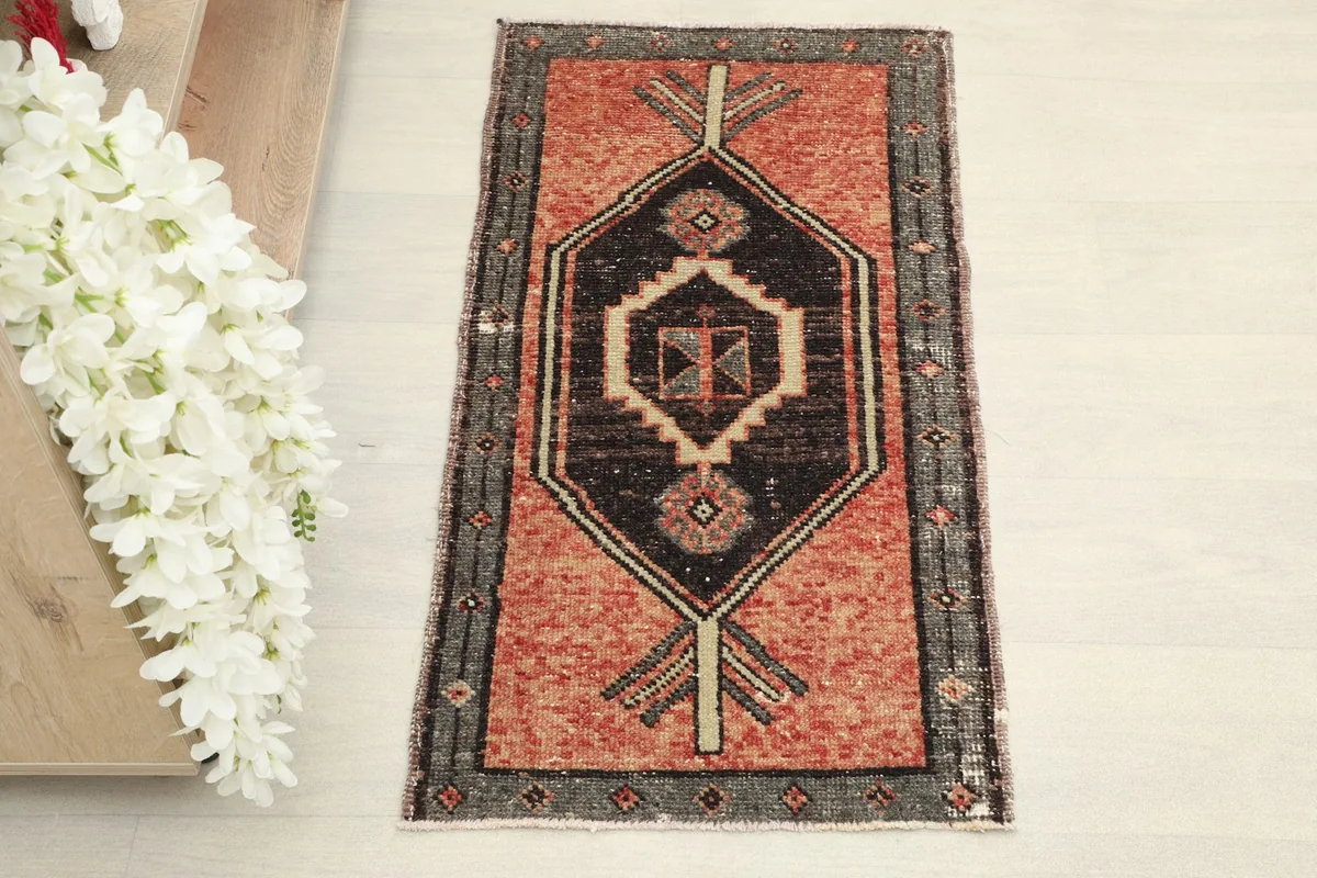 Overhead shot of the vintage Anatolian rug, highlighting the central black medallion and rust field.