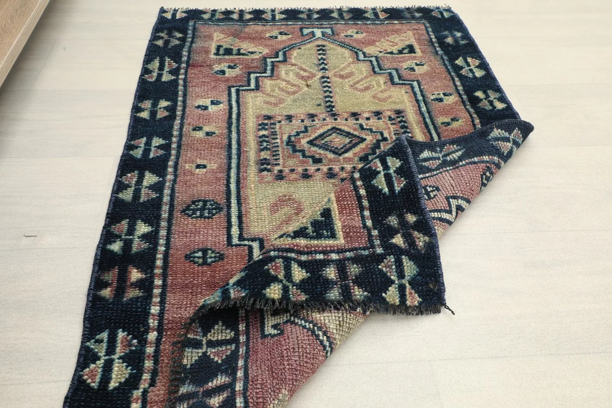 The rug partially folded, illustrating its flexibility and the overall design from a different perspective.