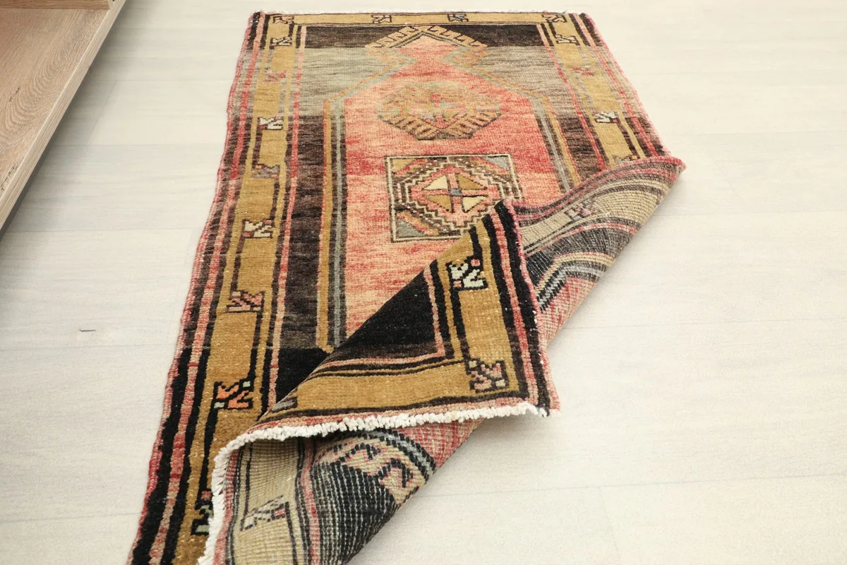 The doormat folded, showcasing the thickness of the wool pile and the construction.