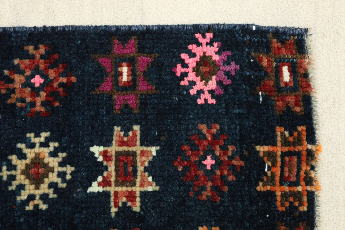 Detail of the runner's end, showcasing the varied colors and slight wear consistent with its vintage nature.
