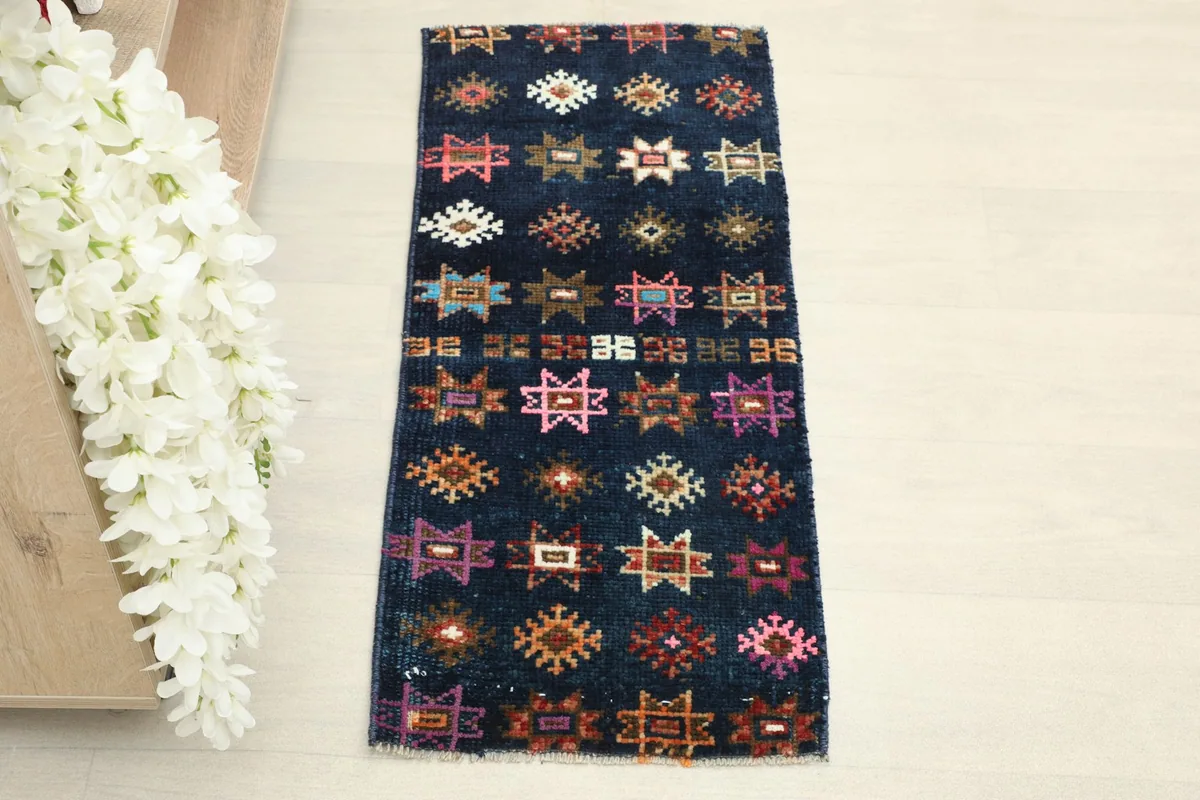 Overhead view of the vintage Anatolian runner, highlighting the navy background and tribal star patterns.