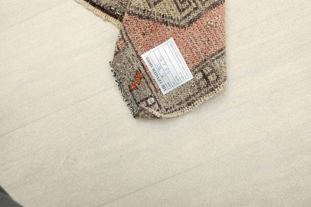 Backside of the hand-knotted rug, revealing the cotton foundation and knotting structure