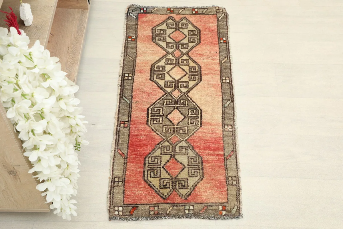 Overhead view of the small hand-knotted rug, highlighting its central geometric design