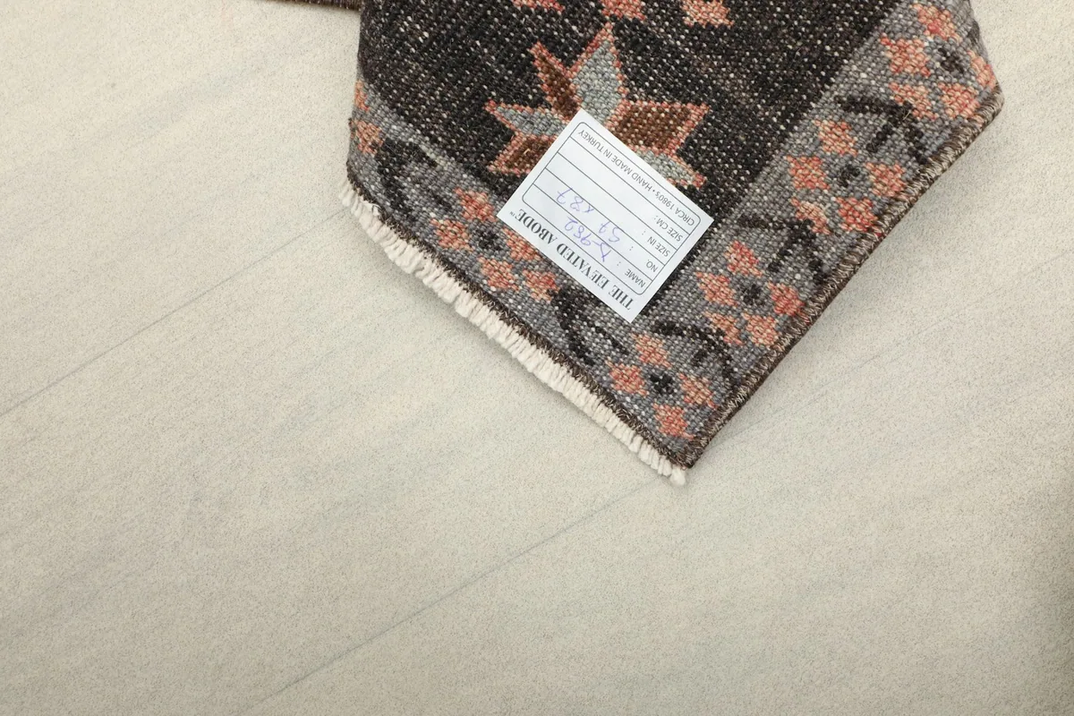 Back corner of the rug with a label, showing the tight knotting and the quality of the wool and cotton.