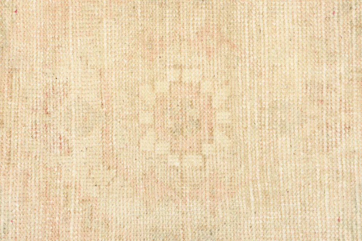 Close-up detail of the central geometric motif and the low wool pile texture