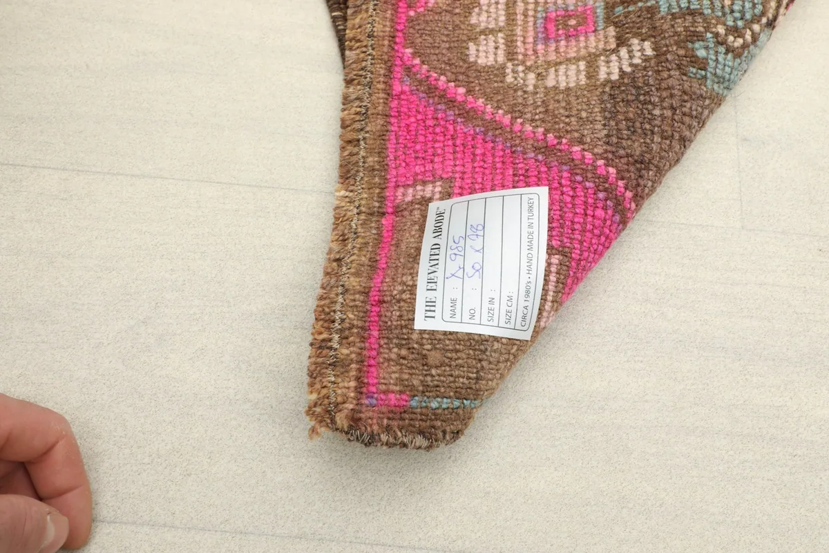 Close-up of the rug's back, revealing the hand-knotted cotton foundation and wool knots