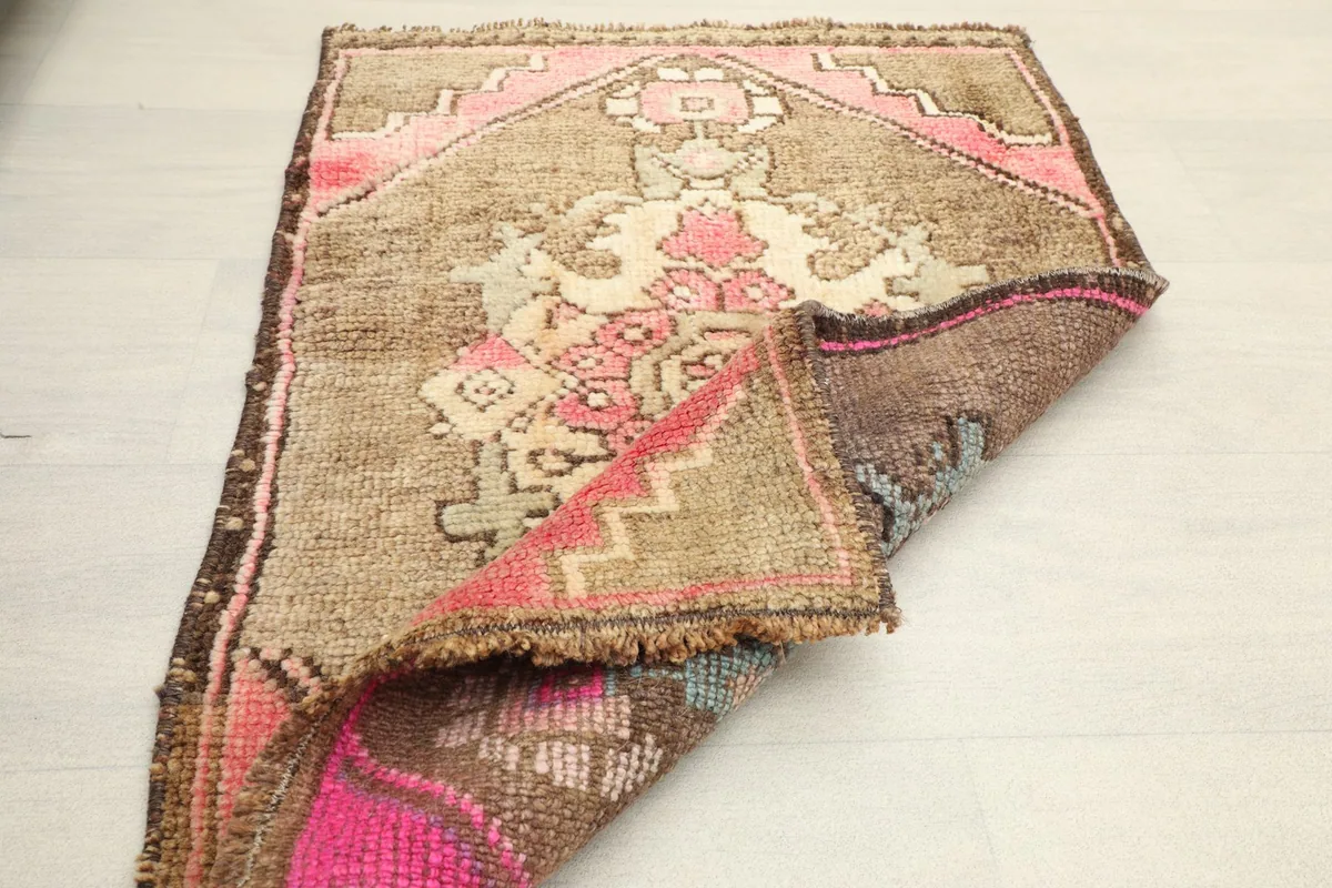 Rug partially folded, showing the back and front textures and colors