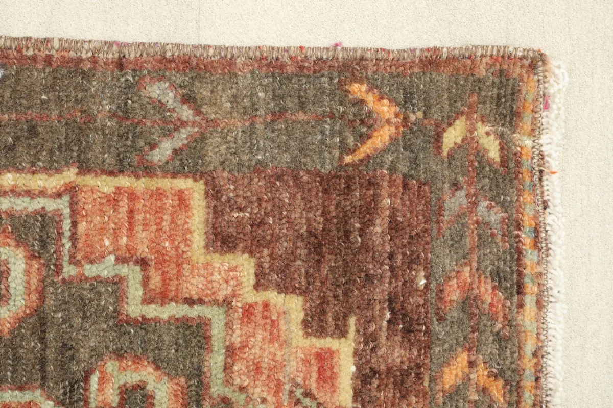 Close-up of the border design and edge finishing of the vintage hand-knotted rug