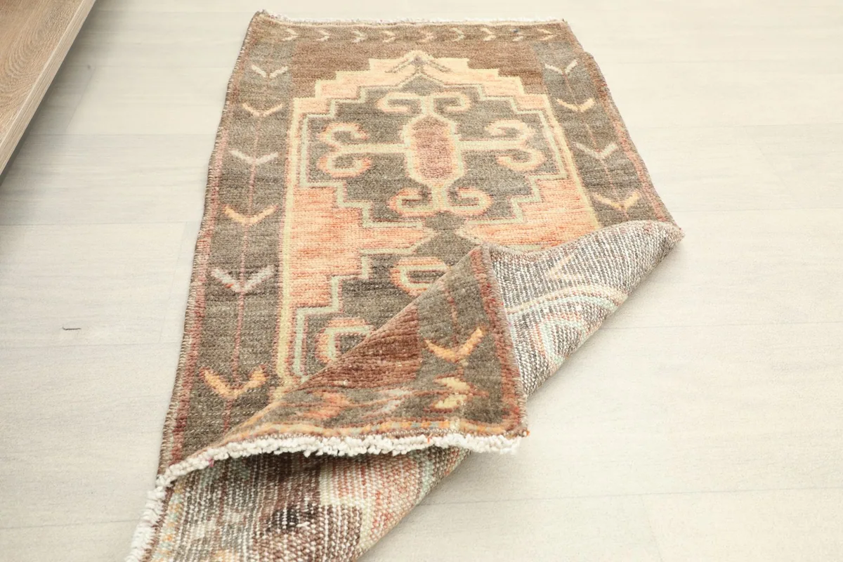 Angled view of the rug with a folded corner, revealing the low wool pile