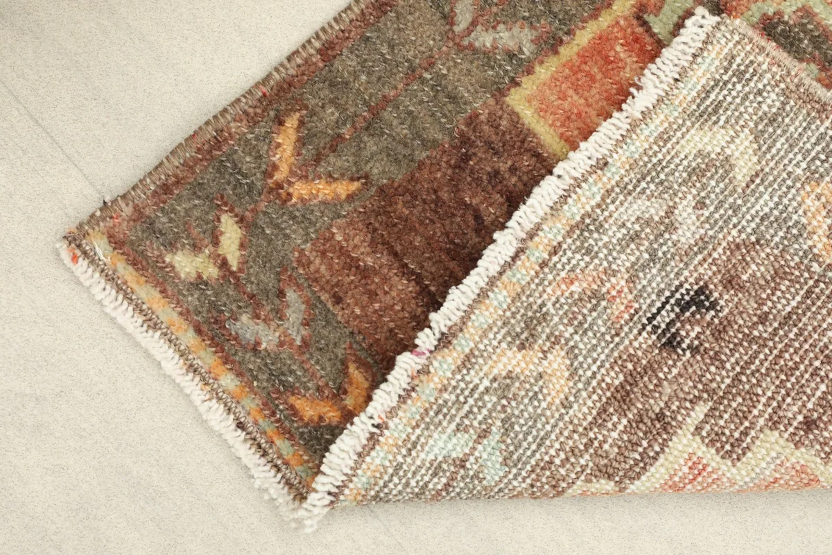 View of the back of the rug, showing the hand-knotted cotton foundation