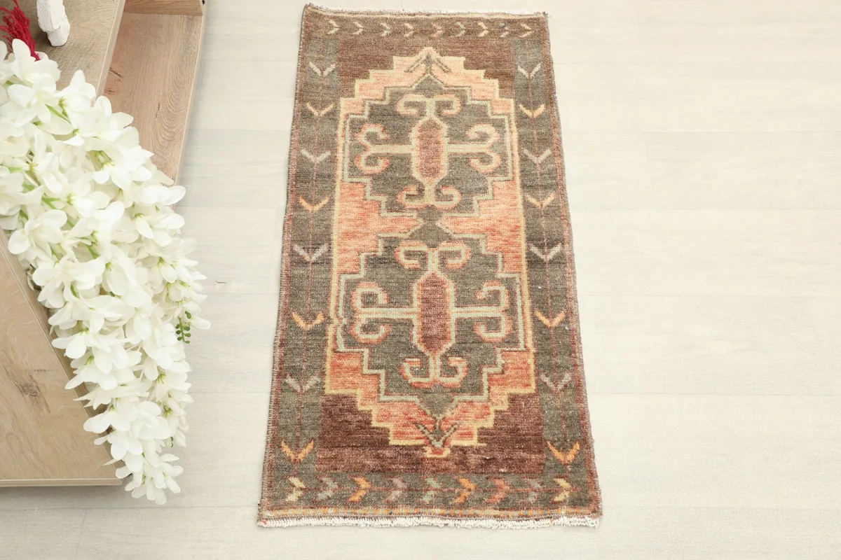 Overhead view showcasing the geometric tribal pattern of the brown and orange rug