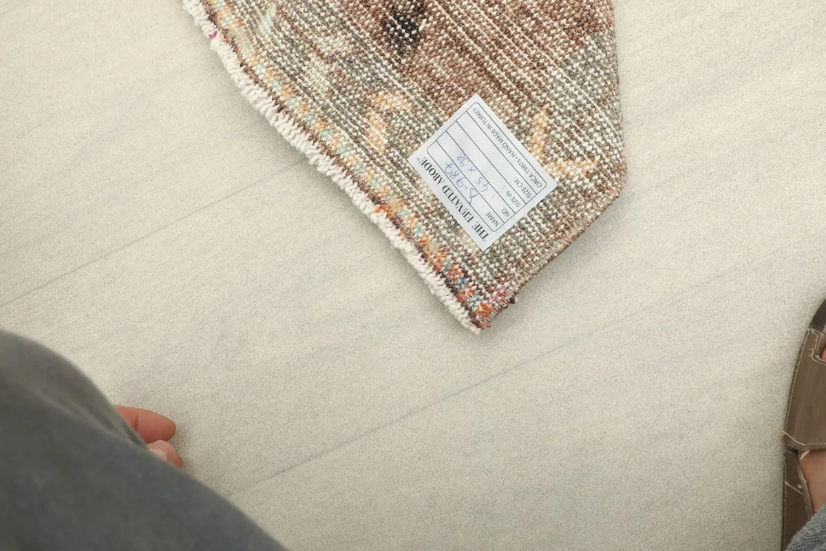 Close-up view of the label on the back of the vintage Anatolian wool rug