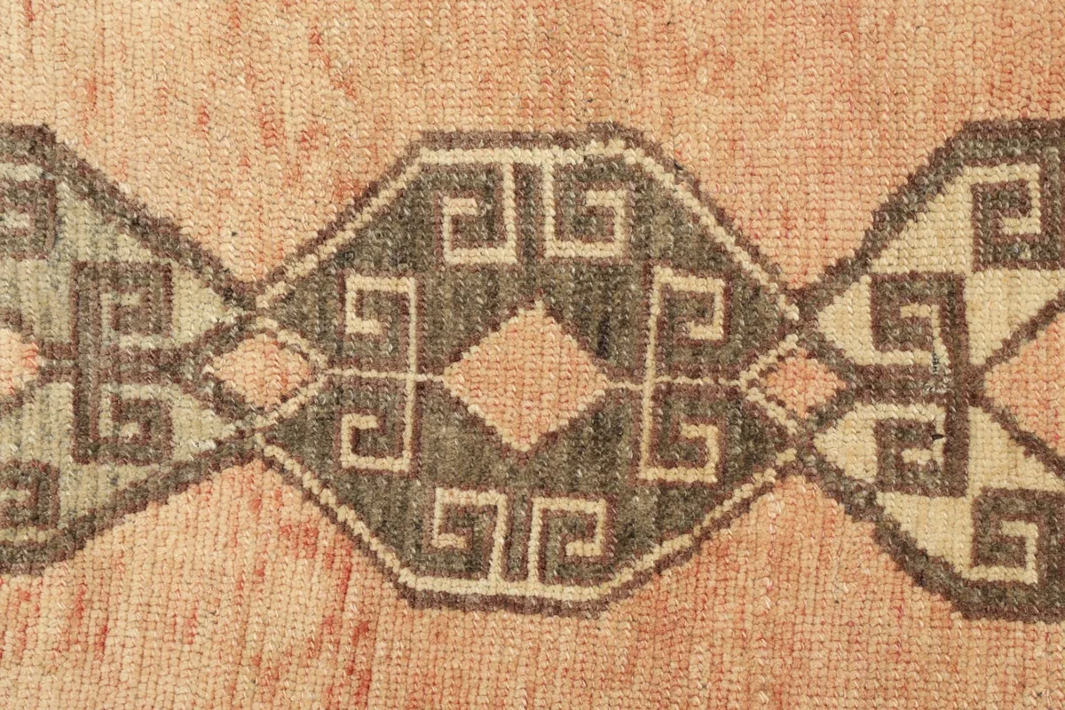 Detailed view of the interlocking geometric patterns and the subtle color variations in the orange field.