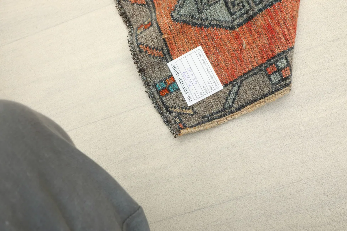 View of the back of the rug, displaying the hand-knotted construction and the raw fringe.