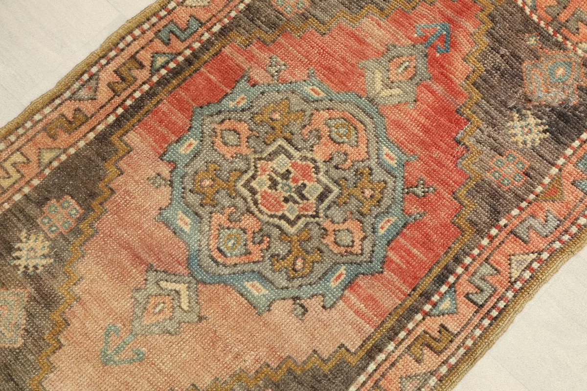 Close-up view of the central blue and gold medallion with rose and brown geometric details