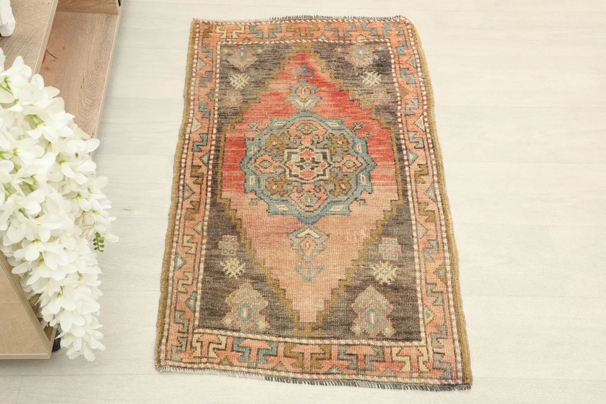 Direct overhead shot of the hand-knotted rose and brown vintage rug, showing full pattern