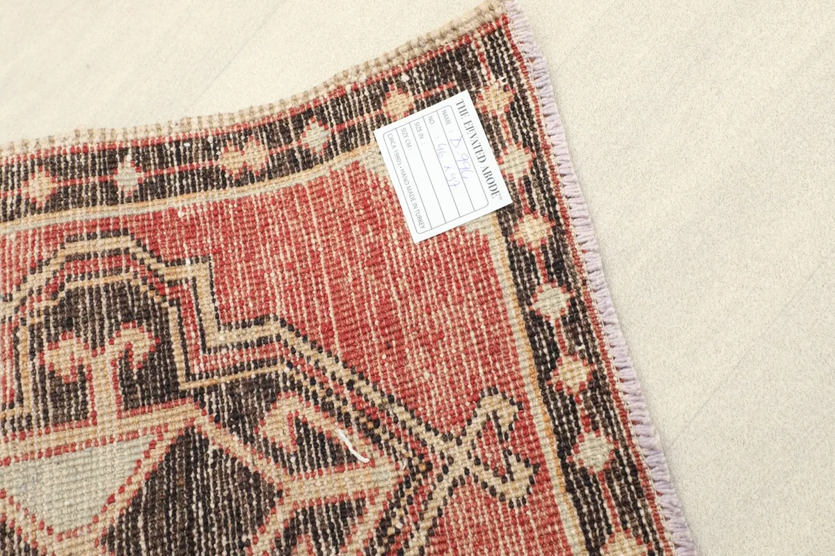 Close-up of the rug's reverse side, showing the hand-knotted cotton foundation and wool knots.