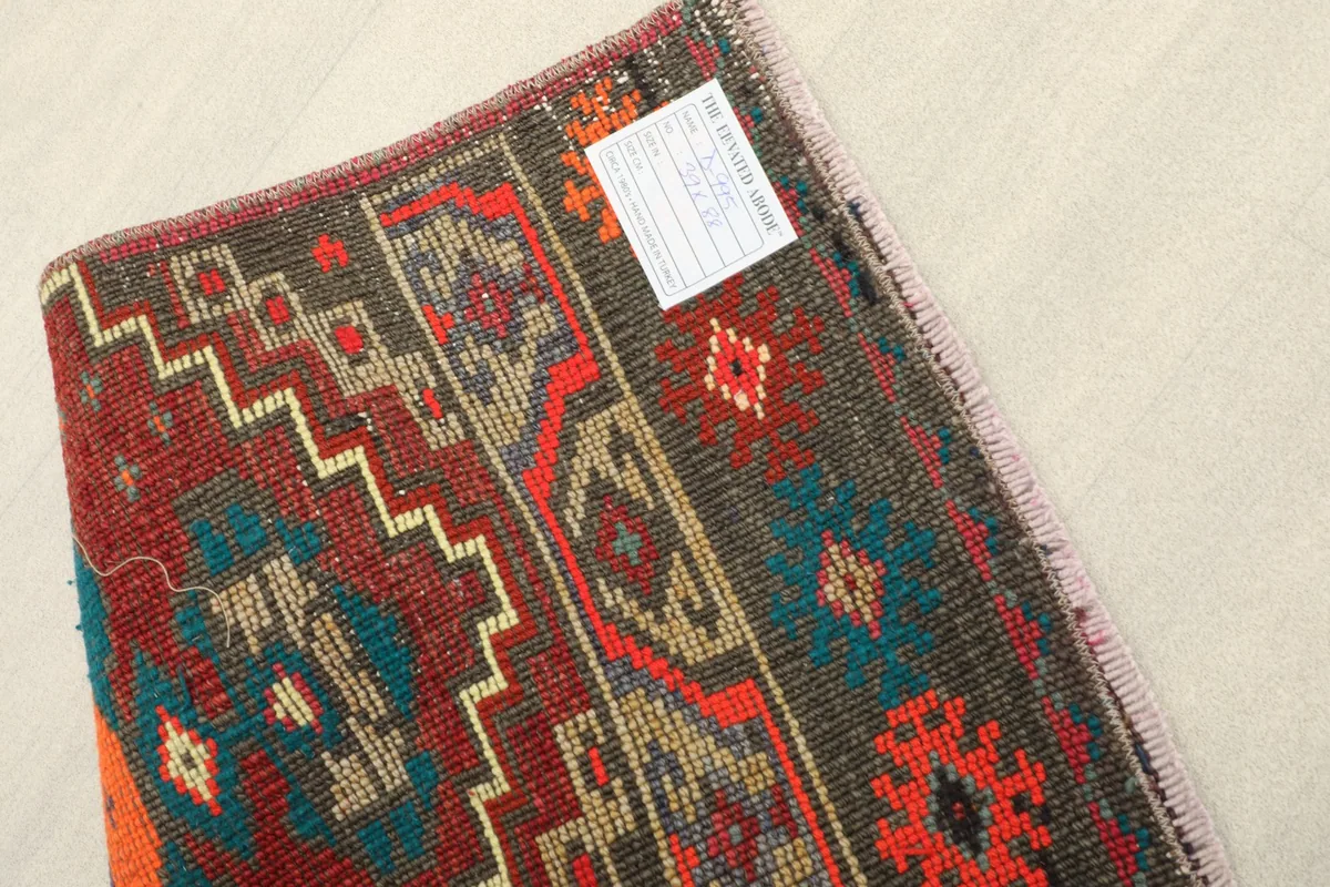 View of the rug's underside, revealing the hand-knotted construction and cotton foundation.