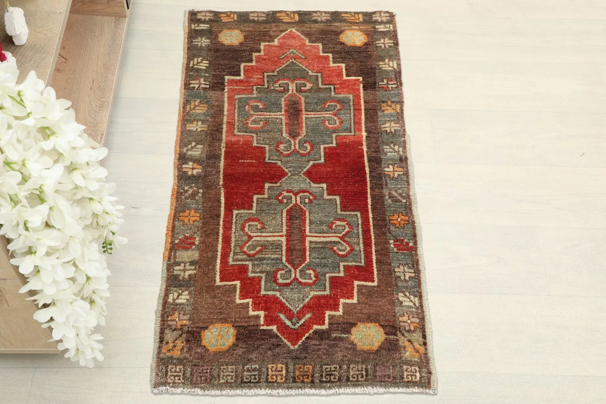 Overhead view showcasing the hand-knotted geometric patterns and colors of the rug