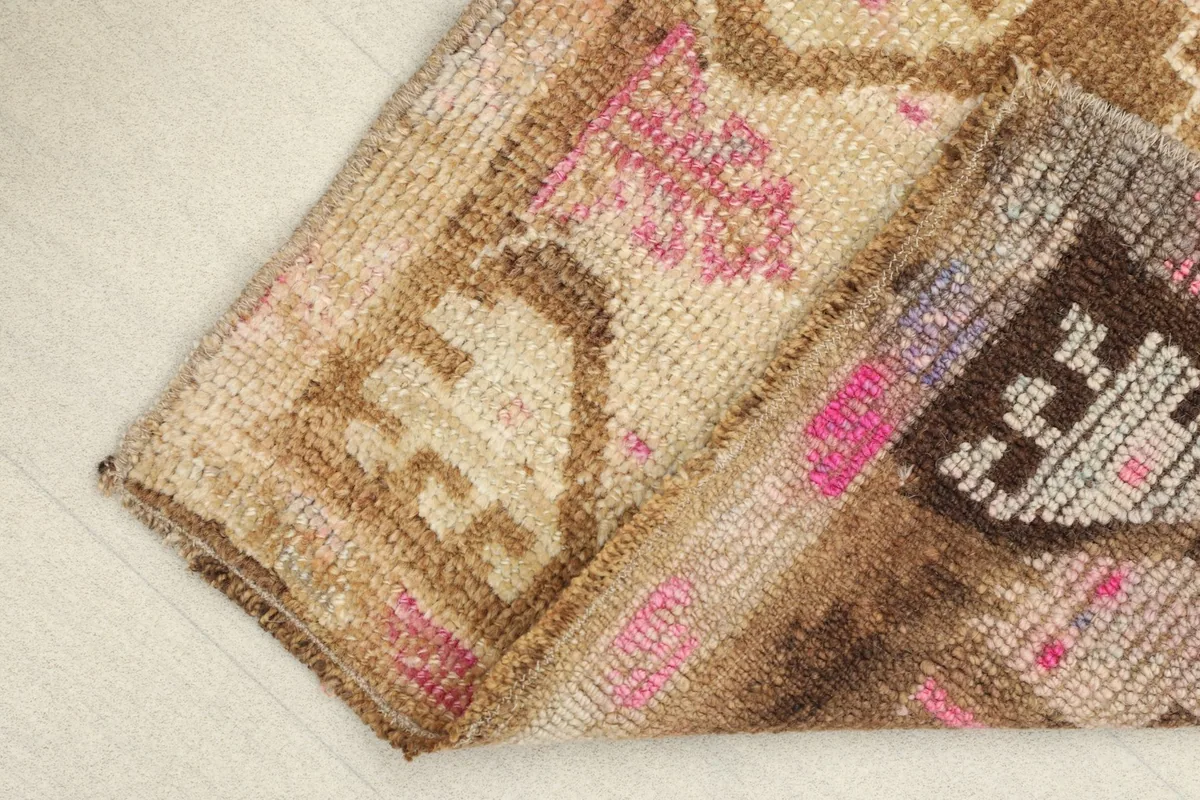 Folded rug section revealing the hand-knotted construction and wool pile texture.