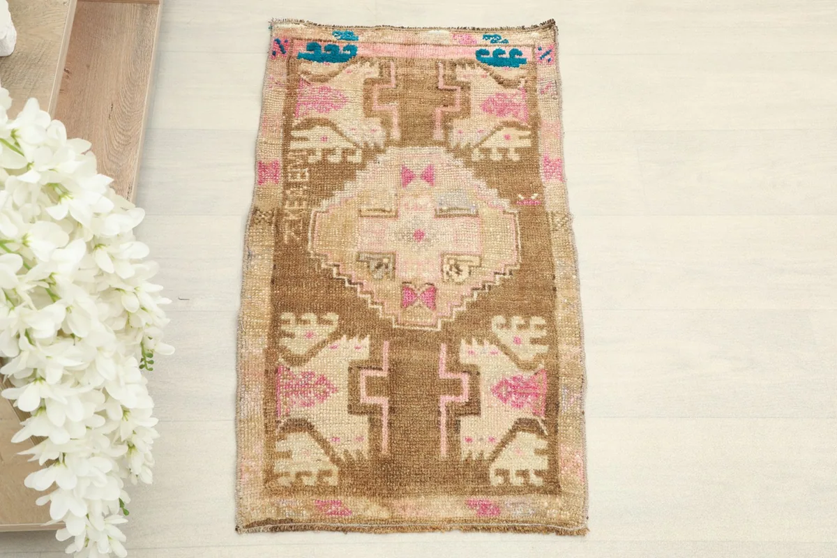 Overhead view of the hand-knotted vintage rug, showing its full design and colors.