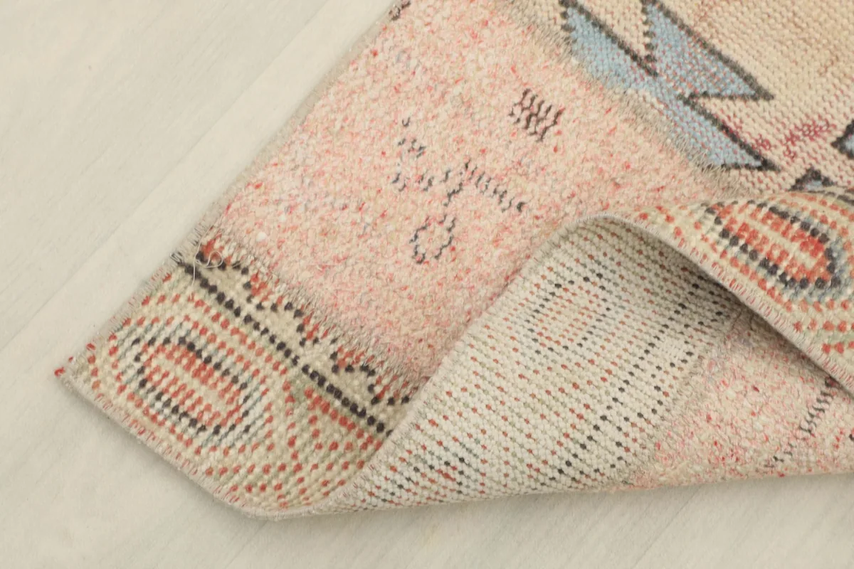 Corner of the runner folded to reveal the hand-knotted wool pile and cotton foundation