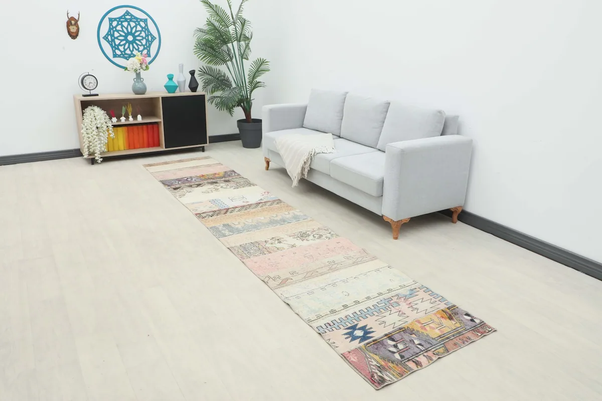 Vintage patchwork runner placed in a modern living space with a light sofa and decor