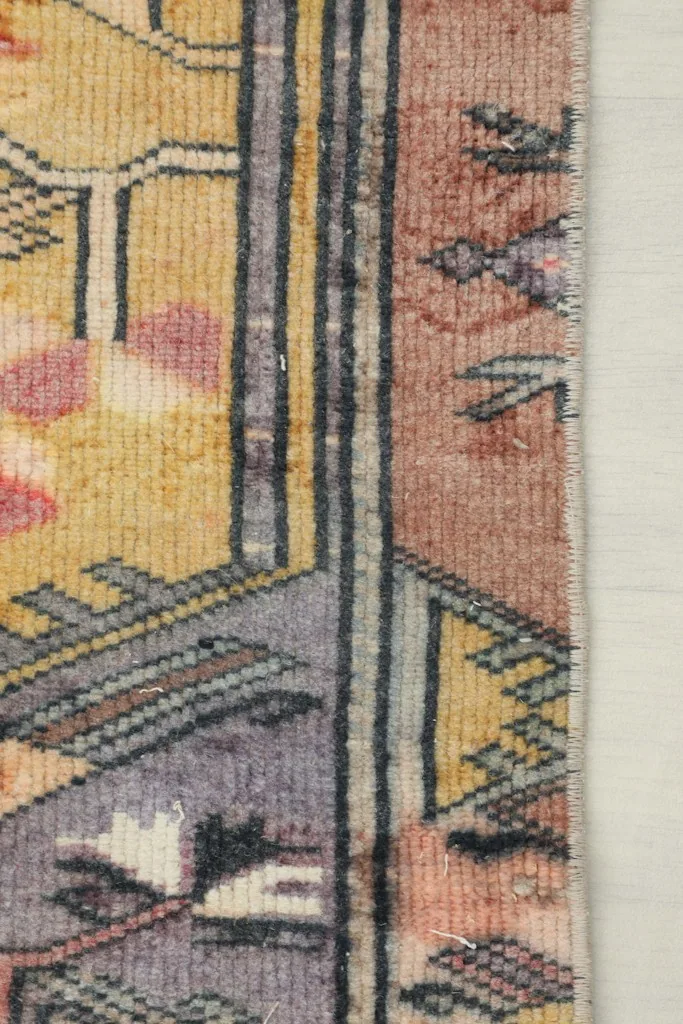 Side view of the rug's edge, illustrating the low pile height and woven structure