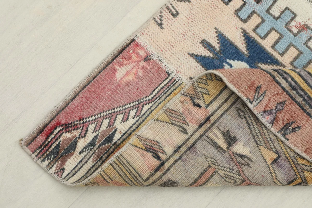 Corner of the runner folded to show the thickness and flexibility of the vintage wool material