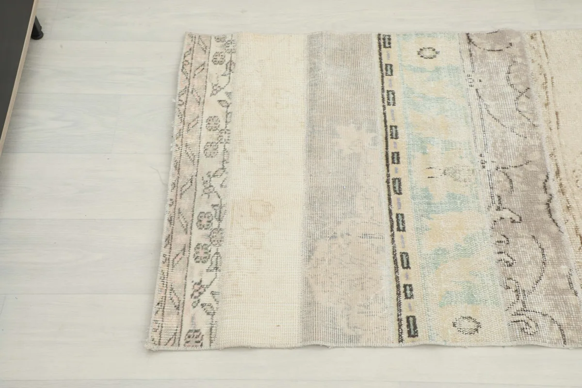 Section of the runner showing varied cream, beige, and gray patches with subtle patterns.